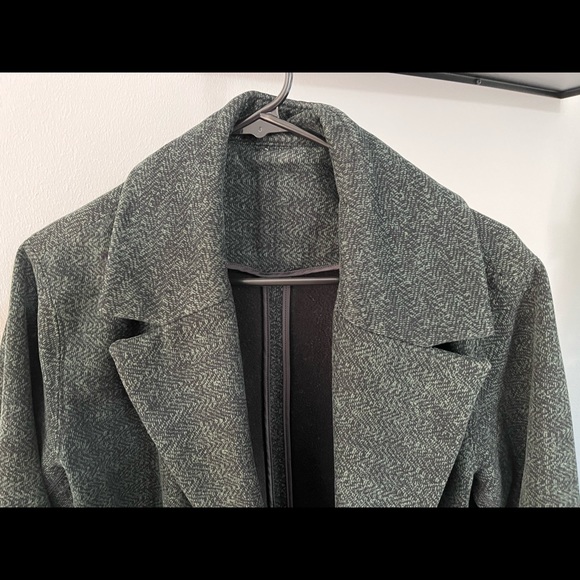This is a lululemon cocoon coat in the color green with specs of black. - Picture 7 of 7